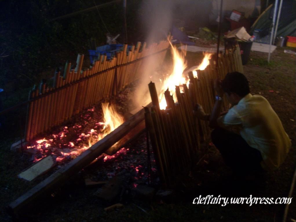 Taking care of the lemang. It takes a lot of heat endurance to get the lemang cooked.